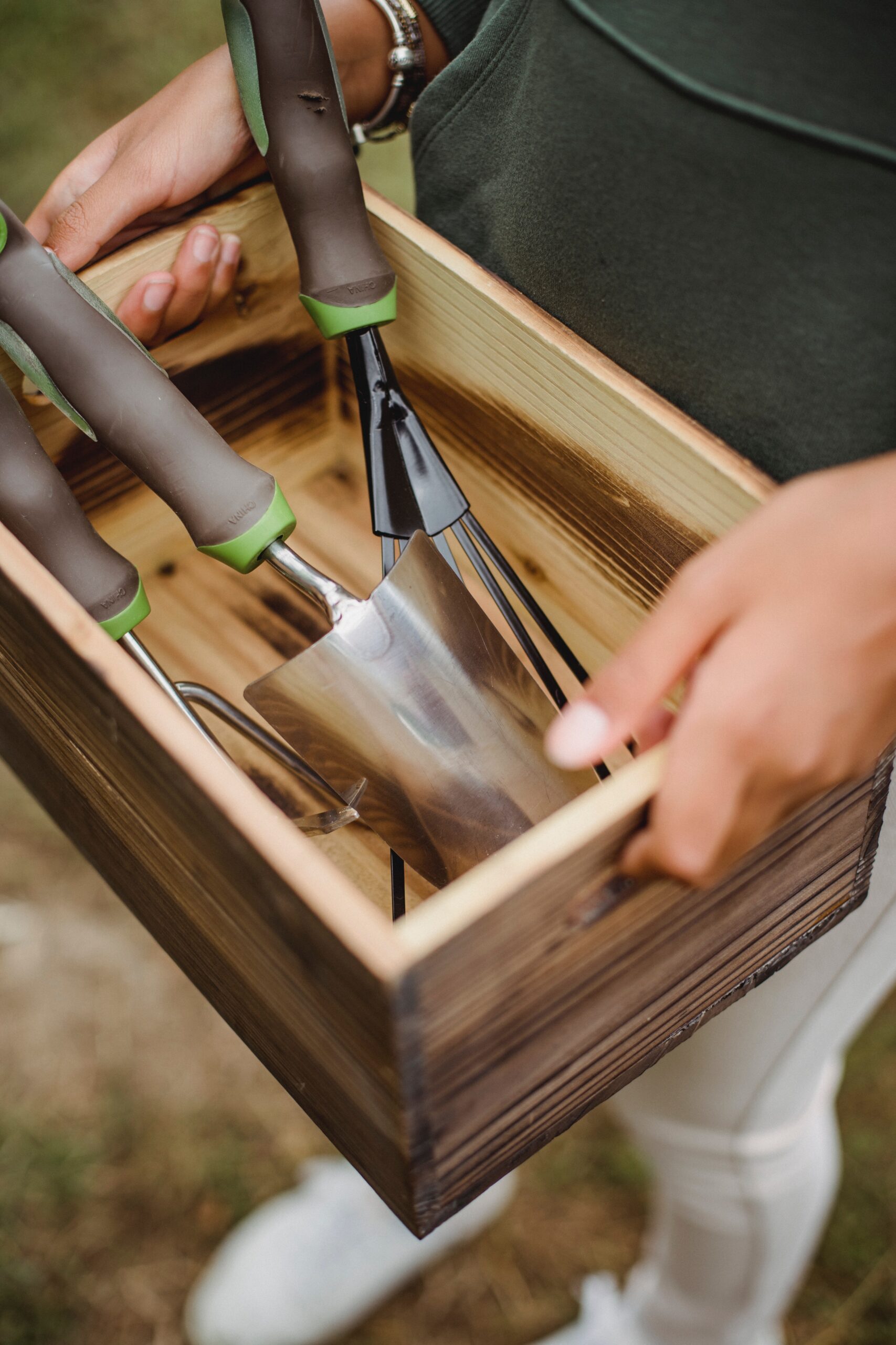 a person holding garden tools